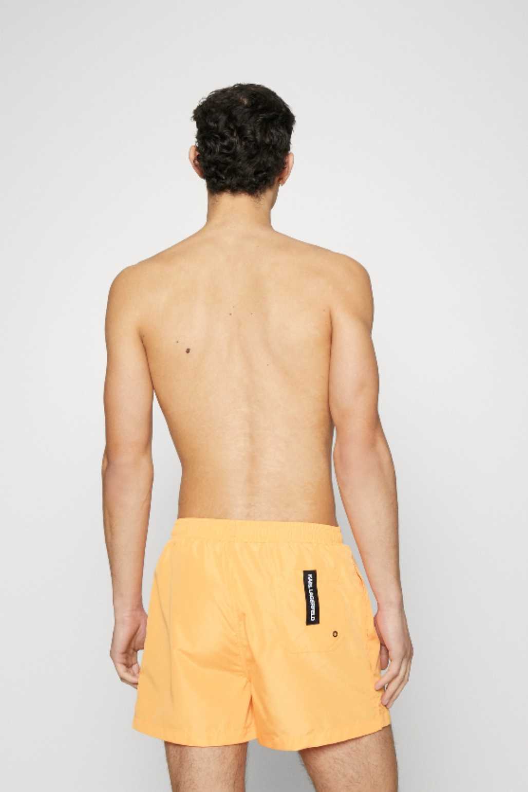 Orange swim trunks with large logo