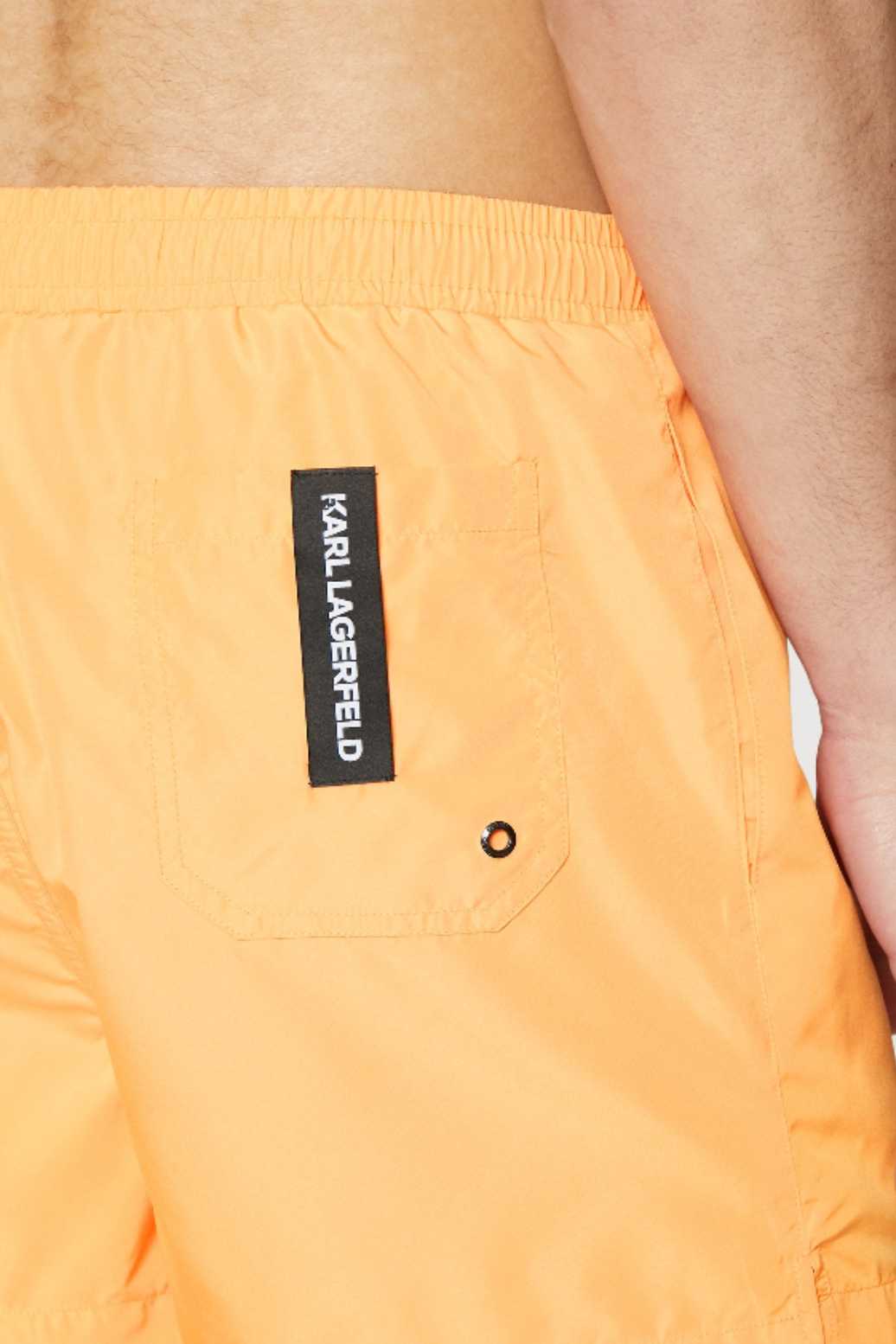 Orange swim trunks with large logo