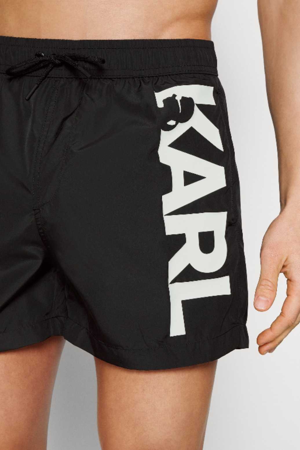 Black swim trunks with large logo