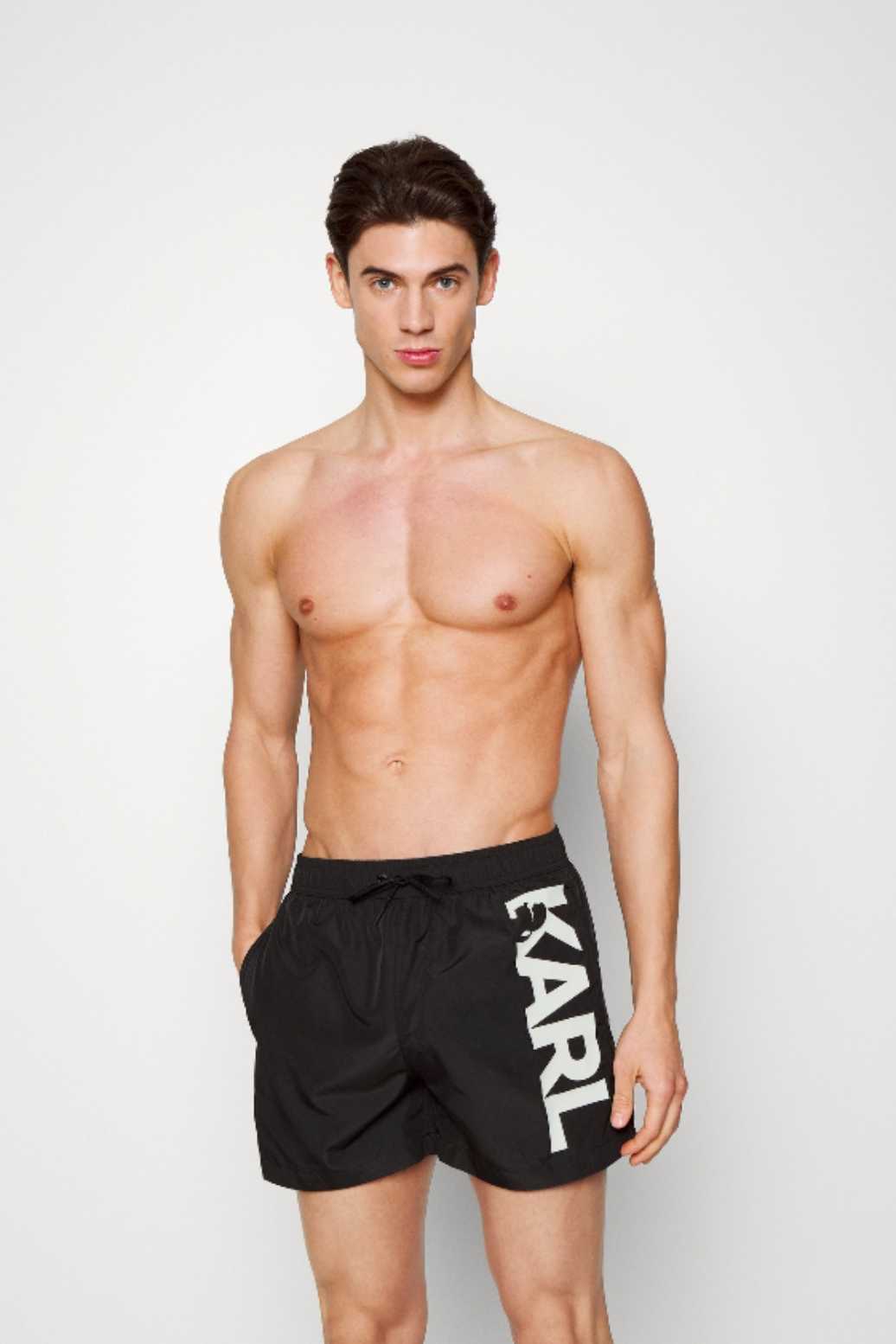 Black swim trunks with large logo